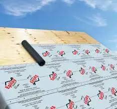 Ultra Freakin Lightweight Superior Synthetic Roofing Underlayment Heavy Duty Polymer Felt Alternative Built Like A Tank For Extreme Temperatures Rock Solid Shingle Base laid on wooden roof deck with blue sky.
