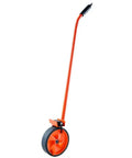 Heavy Duty Steel Measuring Wheel Rig With Thick Solid Tread Built To Smoke Through Loose Dirt And Gravel While Delivering Straight Shooter Foot Readings For Landscaping Crews Out Back with orange handle and large tire.