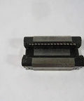 Top view of 15 mm runner block with pulley and bushing, single linear slide unit R162211420, black and metallic parts visible