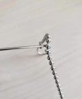 Close-up of fish ball chain with retractable retriever hook, part of 10 feet length wall wiring tool, showing stop ring to prevent dropping.