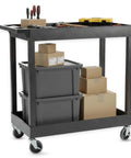 32 Inch Tub Storage Cart With Two Shelves Black Built For Maximum Capacity Ergonomic Top Handle And Super Handy Maneuver Four Swivel Casters With Two Locking Brakes Molded Plastic Shelves And Legs Won't Stain Scratch Dent Or Rust, loaded with boxes and tools