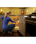 Person using 32 Inch Kidney Shaped Dual Tier Lazy Susan Organizer For Corner Base Kitchen Cabinets In White Polymer With Telescoping Shaft