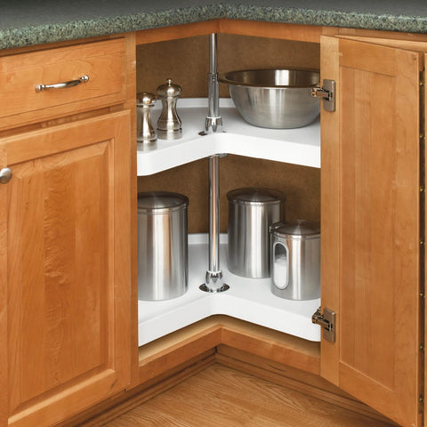 32 Inch Kidney Shaped Dual Tier Lazy Susan Organizer For Corner Base Kitchen Cabinets In White Polymer With Telescoping Shaft And Mounting Hardware Maximizes Corner Kitchen Space And Easy Install in a kitchen cabinet, stocked with stainless containers and spices.