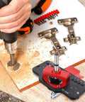 Hand using Concealed 35mm Cabinet Hinges With Foldable Soft Close Retrofit Design And Drill Locator Tool Kit for woodworking