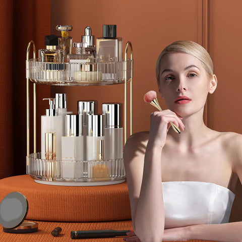 Woman seated by 360 Degree Rotating Makeup Organizer and Storage for Vanity and Countertop High Capacity Cosmetic Skincare and Perfume Organizer with Two Tiers in Clear White Lazy Susan for Dresser.