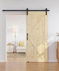36 in x 84 in Sliding Barn Door with 6.6 ft hardware kit included, unfinished solid spruce wood door installed in living room doorway.