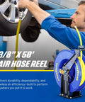 Mechanic using a Retractable Air Hose Reel Three-Eighths Inch By 50-Foot Heavy Duty Premium SBR Hose Up To 300 Psi Reinforced Steel Construction Spring Driven Industrial Dual Arm And Pedestal The Workhorse For Your Workshop Or Garage in a garage setting