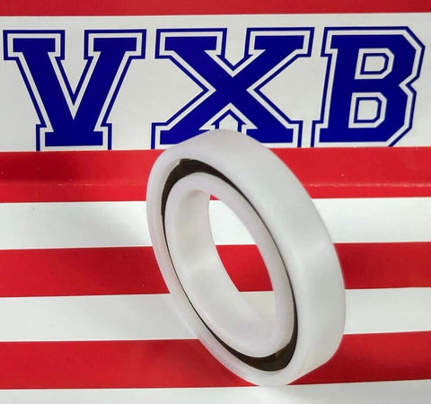 Acetal/POM Plastic Bearing 6906 - Glass Balls - 30x47x9mm, side view, with white polymer raceway on striped background