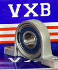 15mm Bore Miniature Stainless Steel Pillow Block Mounted Bearing on blue and red background.