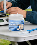 3D Printer Lube Kit 100g Bearing Oil with Brush Gear Grease displayed next to a 3D printer in a home workshop setting