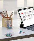 Tablet next to 400 Pcs Clear 3x4 Inch Jewelry Bags 2 Mil Resealable Zip Bags and binder clips on a desk.