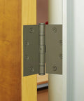 4 Pack Four And One Half Inch Ball Bearing Door Hinges With Prime Coat installed on wooden interior door for quiet operation