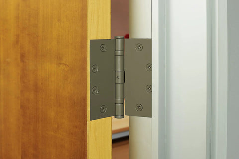 4 Pack Four And One Half Inch Ball Bearing Door Hinges With Prime Coat installed on wooden interior door for quiet operation