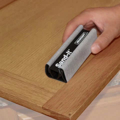 Hand using 4 In 1 Sanding Block For Flat Convex Concave And Round Surfaces on wooden corner