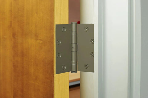 Installed 4 Pack 4.5 Inch Ball Bearing Door Hinges Prime Coated for smooth opening on wooden commercial door