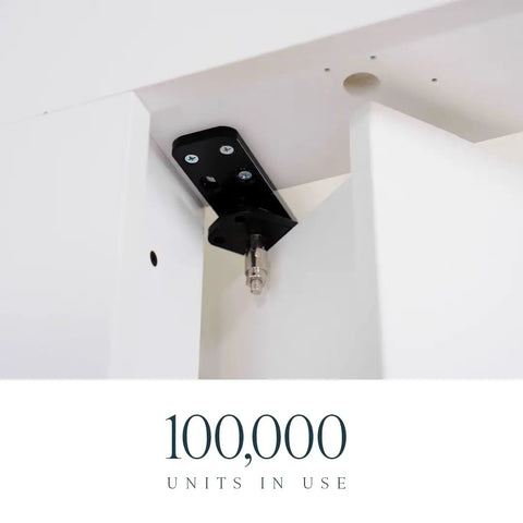 Close-up of Solid As A Rock Hidden Hinge Hardware Bundle mounted on white doors, showcasing matte black finish and sturdy design.
