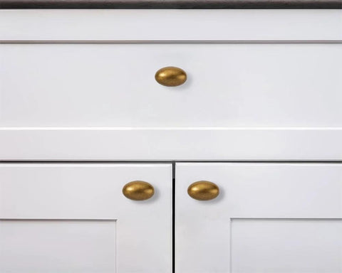 Antique Brass Cabinet Knobs 10 Pack 1-3/8 Inch Oval Drawer Knobs installed on white kitchen cabinets
