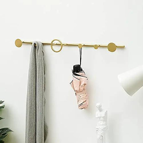 Modern Wrought Iron Coat Hook With Gold Finish Space Saving Wall Mount For Entryway And Porch Smooth Rounded Design Rust Resistant, holding a scarf and umbrella.