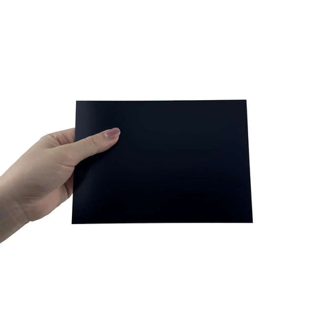 Hand holding Premium Black Anodized Aluminum Sheets 5x7 Inch One Thirty Second Inch 0.8mm Corrosion Resistant Plates for DIY crafts