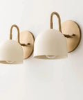 Modern Brass Bowl Wall Sconce - Mid Century Modern Light Fixture Pair (Set of 2) with cream shades mounted on a wall.