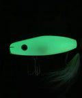 Glowing 4.5 Inch Wood Lure With Stainless Diving Lip in dark, showcasing durable basswood build for saltwater action.