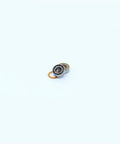 Close-up of a single orange sealed 4x8x3mm bearing from 10 Pack MR84RS MR84-2RS Color Ball Bearings for Hobby RC Cars and Trucks.
