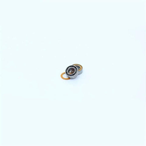 Close-up of a single orange sealed 4x8x3mm bearing from 10 Pack MR84RS MR84-2RS Color Ball Bearings for Hobby RC Cars and Trucks.