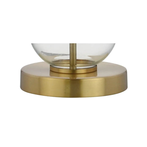 Close-up of brass base and glass sphere of Clear Glass Triple-Sphere Table Lamps Set Of 2 With Brass Accents And White Linen Shade 27-Inch