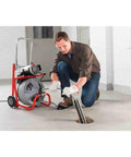 Professional using Heavy Duty 115 Volt Electric Conduit Bender Machine Featuring Autofeed and C45 Integral Wound Cable to bend rigid pipe.