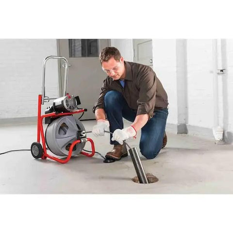 Professional using Heavy Duty 115 Volt Electric Conduit Bender Machine Featuring Autofeed and C45 Integral Wound Cable to bend rigid pipe.