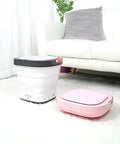 Total Game Changer Portable Mini Washing Machine With Foldaway Compact Build For Grabbing Laundry On The Fly Lightweight Gray Automatic Clothes Washer displayed with a pink unit.