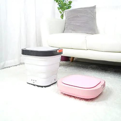 Total Game Changer Portable Mini Washing Machine With Foldaway Compact Build For Grabbing Laundry On The Fly Lightweight Gray Automatic Clothes Washer displayed with a pink unit.