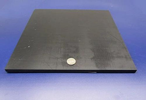 UHMW PE Black Sheets Set Of Two Three Eighths Inch Thick Twelve By Twelve Inches Durable Wear Resistant Workhorse Surface With Serious Impact Strength Meets ASTM D 4020 05 Compliance. Square black sheet with coin for scale on blue background.