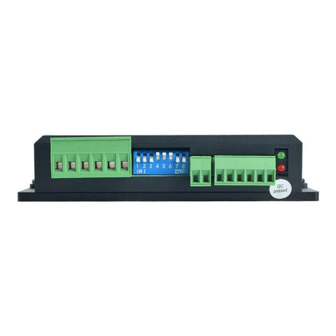 DM556T digital stepper driver module, front view; blue DIP switches with green terminal blocks.