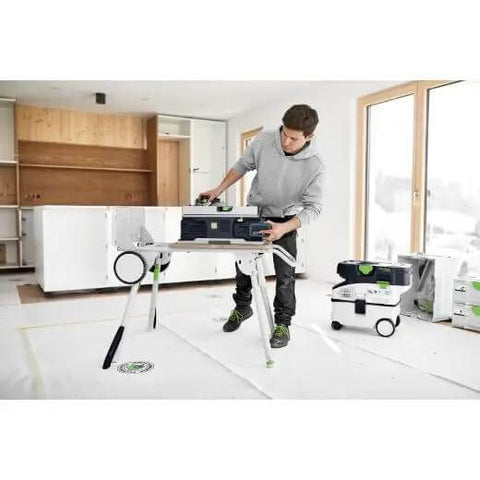 Cordless Table Saw With Battery Powered Circular Blade For Drop Dead Accurate Miter And Parallel Cuts Compact Portable Benchtop Tool in a wooden interior.