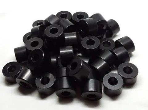 Pile of Half Inch Aluminum Spacer Black Anodized Round Unthreaded Standoff Bushing with Quarter Inch Inner Diameter For Quarter Inch Screws Or M6 Bolts