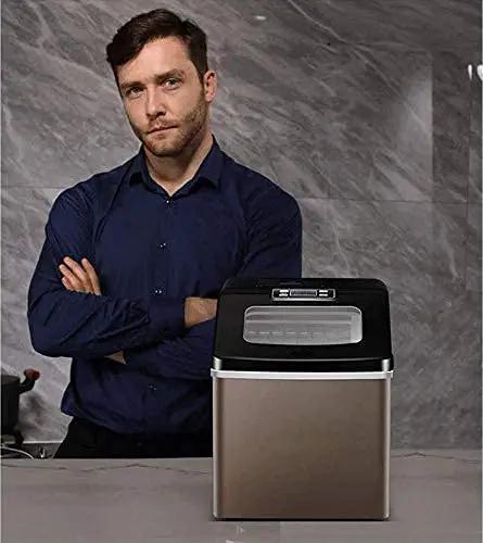 Top Shelf Portable Countertop Ice Maker Machine Snaps Frosty Cubes In Minutes Transparent Viewing Window Food Safe Abs Body positioned in a kitchen.