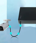 Compact Mini UPS Battery Backup For 12 Volt Routers Cameras And Speakers Emergency Standby Power Supply connected to a security camera.