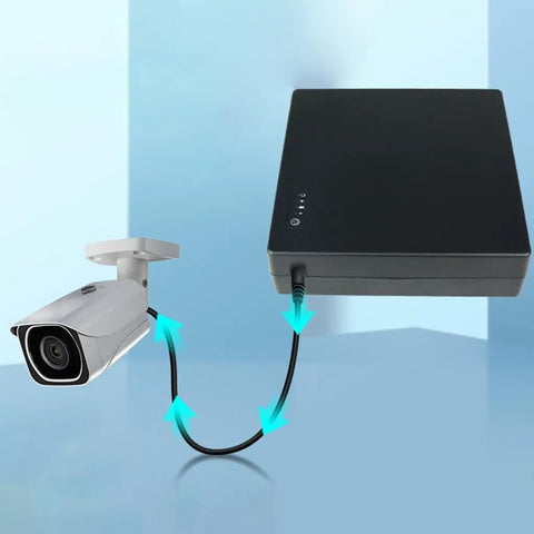 Compact Mini UPS Battery Backup For 12 Volt Routers Cameras And Speakers Emergency Standby Power Supply connected to a security camera.