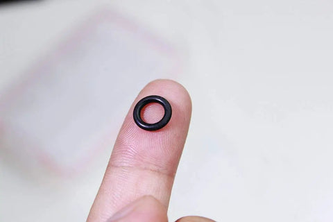 Durable Silicone Wacky Rig O Rings For 4 To 5 Inch Senko Worms Elastic Rings That Prevent Tears Keeps Baits Secure And Let Soft Plastics Fall Naturally Includes 100 Rings And Tackle Box Storage For Easy Fishing Setup black ring on fingertip