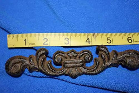 Straight Up Classic Victorian Swirl Cast Iron Drawer Pulls Set Of 20 For Furniture And Cabinet Restoration 6 1/4 Inch close-up of brown drawer pull with ruler for size reference
