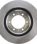 Front view of Centric 121.44129 C-Tek front brake rotor; silver metal with hub mounting holes for Toyota