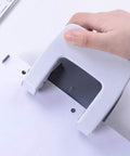 Hand using Two Hole Puncher For Paper And Crafts, Adjustable 3.15 Inch Hole Spacing, Squeeze To Punch Up To 20 Sheets, White Finish.