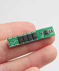 Solid 5 Pack 1S 3.7V 10A Lithium Ion BMS Protection Boards, compact green circuit board in hand for battery protection.