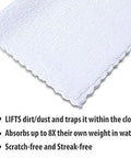 Close-up of white microfiber cleaning cloth with scalloped edge, 12x12 inches.