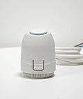 White 24V normally closed electric actuator for underfloor heating, front view with blue ring