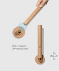 Rechargeable Battery Operated Wall Sconce Night Light With 360 Degree Rotating Magnetic Ball, wooden finish, hand demonstrating use