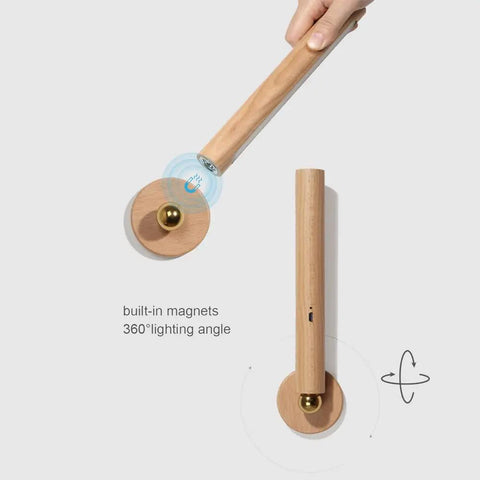Rechargeable Battery Operated Wall Sconce Night Light With 360 Degree Rotating Magnetic Ball, wooden finish, hand demonstrating use