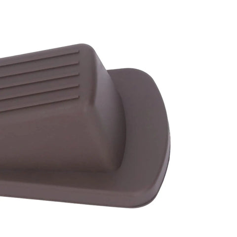 Close-up of brown TPR door stop from 10 Pack TPR Wedge Door Stops for Home Office Durable No Punching Design Flexible Rubber for Carpet Tile Wood Floors Reduces Collision Noise and Ground Damage on Slick Surfaces.