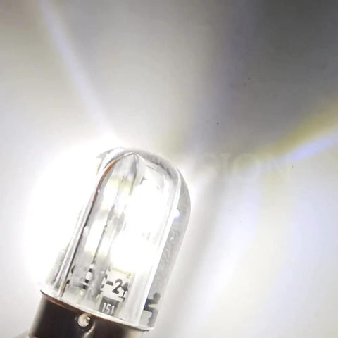 Close-up of BA9S LED Indicator Bulb 120V AC DC in cool white light, ideal for industrial control panels, switchgear status, and machine tool signals.